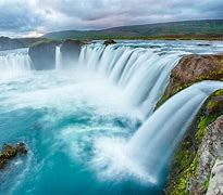 Image of multiple waterfalls that go into a lake